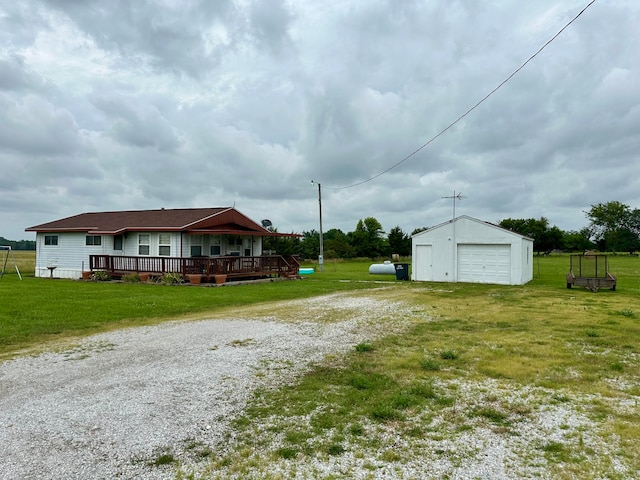 view of yard featuring a garage, an outdoor structure, and a deck