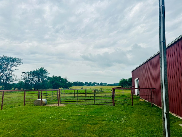 view of yard featuring a rural view and an outbuilding