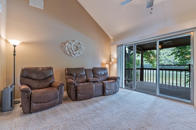 carpeted living room featuring ceiling fan and high vaulted ceiling