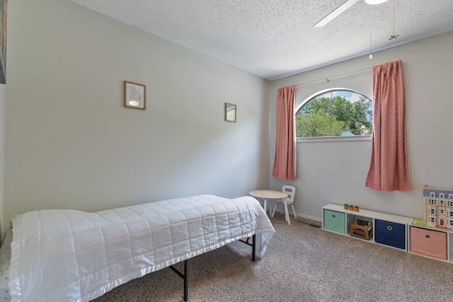 bedroom featuring carpet, a textured ceiling, and ceiling fan