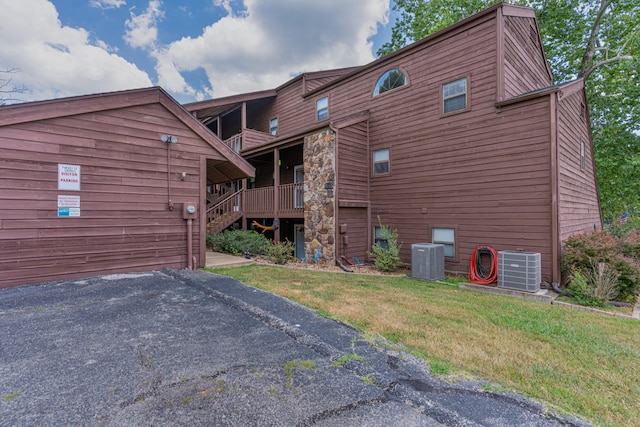 exterior space featuring central AC unit and a yard