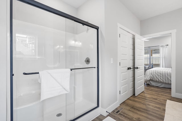 bathroom featuring walk in shower and hardwood / wood-style flooring