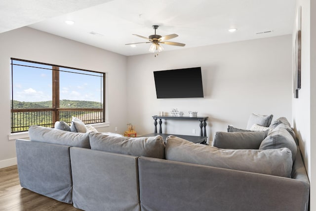 living room with hardwood / wood-style flooring and ceiling fan