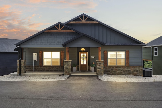 craftsman house featuring cooling unit and a porch