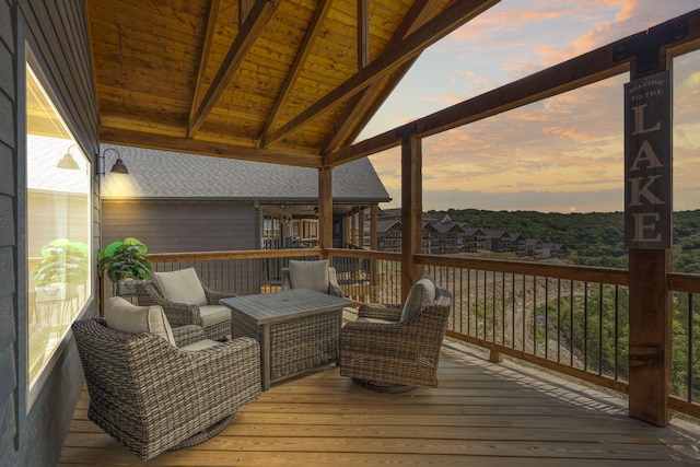 deck at dusk with outdoor lounge area