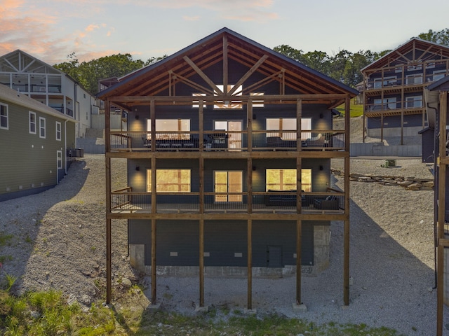 back house at dusk with a balcony