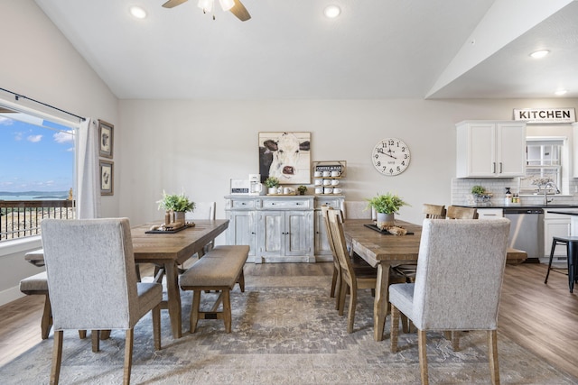 dining area featuring lofted ceiling, ceiling fan, and hardwood / wood-style floors