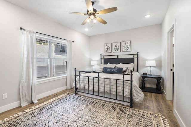 bedroom with ceiling fan and dark hardwood / wood-style flooring