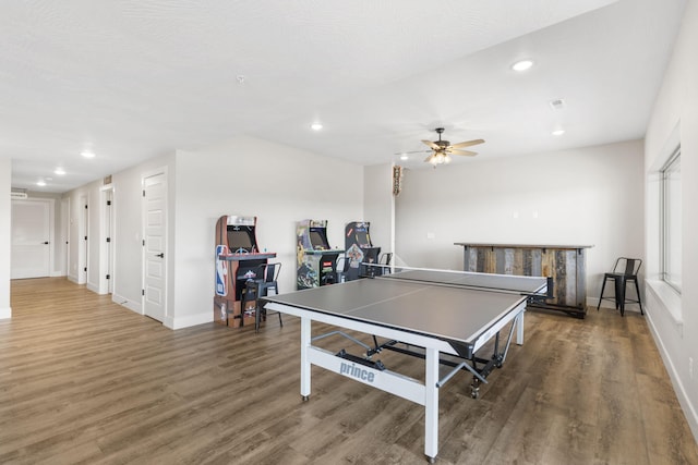 recreation room featuring ceiling fan and dark hardwood / wood-style flooring