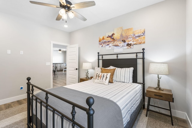 bedroom with hardwood / wood-style floors and ceiling fan