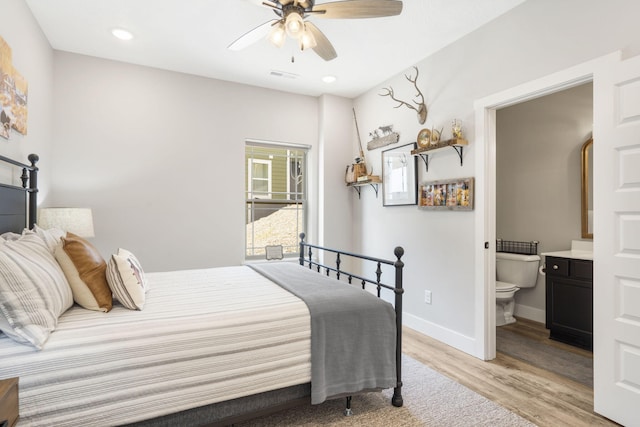 bedroom featuring ceiling fan, light wood-type flooring, and connected bathroom