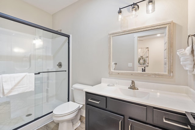 bathroom featuring an enclosed shower, vanity, and toilet