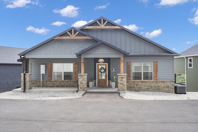 craftsman inspired home with central AC unit and covered porch