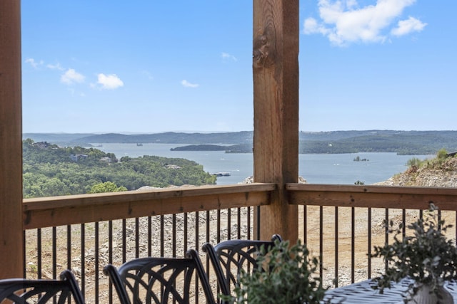 deck with a water and mountain view