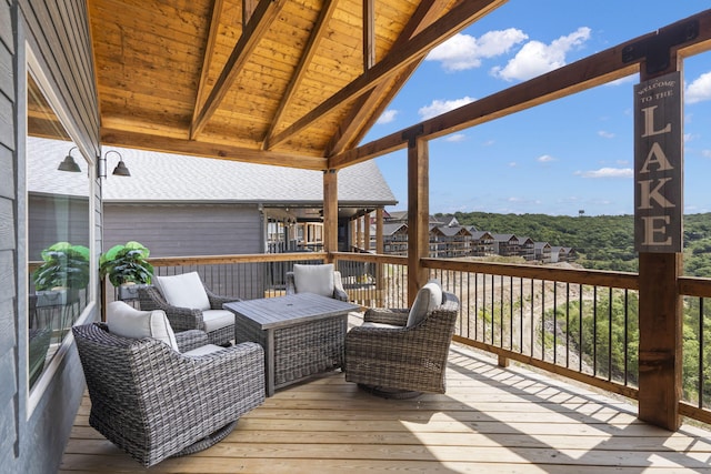 wooden deck with an outdoor living space