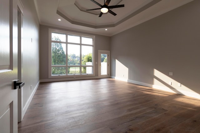 spare room with crown molding, ceiling fan, hardwood / wood-style floors, and a raised ceiling