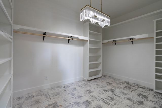 walk in closet featuring light colored carpet