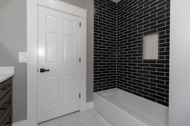 bathroom featuring tiled shower / bath, vanity, and tile patterned floors