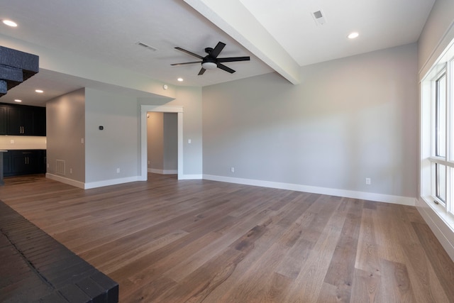 unfurnished living room with ceiling fan, beamed ceiling, and hardwood / wood-style floors