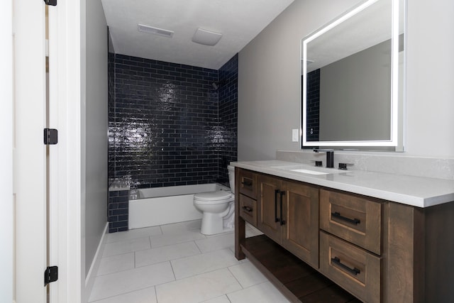 full bathroom featuring vanity, tiled shower / bath combo, toilet, and tile patterned flooring