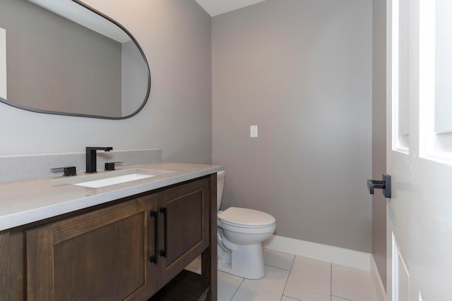 bathroom featuring tile patterned floors, vanity, and toilet