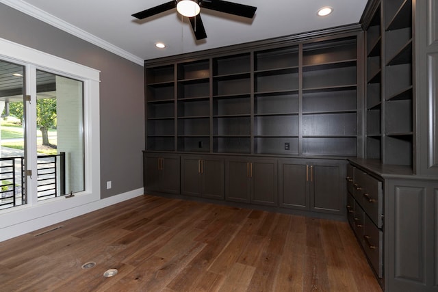 interior space featuring dark hardwood / wood-style floors, crown molding, and ceiling fan