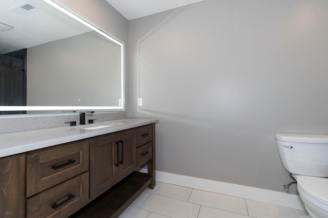 bathroom featuring tile patterned floors, vanity, and toilet