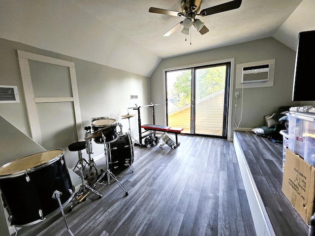 interior space featuring ceiling fan, dark wood-type flooring, vaulted ceiling, and a wall mounted AC