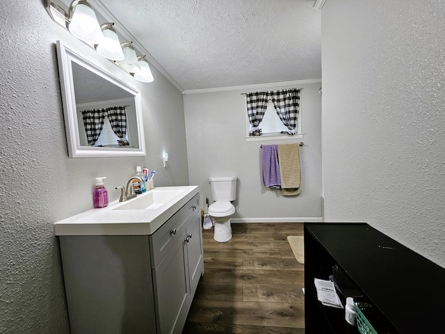 bathroom with vanity, hardwood / wood-style floors, toilet, and crown molding