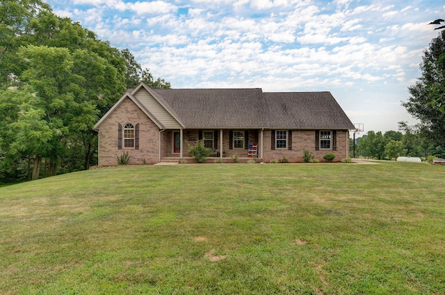 single story home featuring brick siding, a front lawn, roof with shingles, and a porch