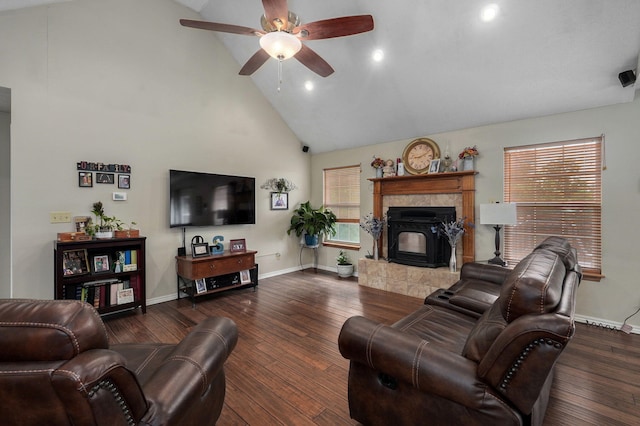 living room with a tiled fireplace, high vaulted ceiling, ceiling fan, and dark hardwood / wood-style floors