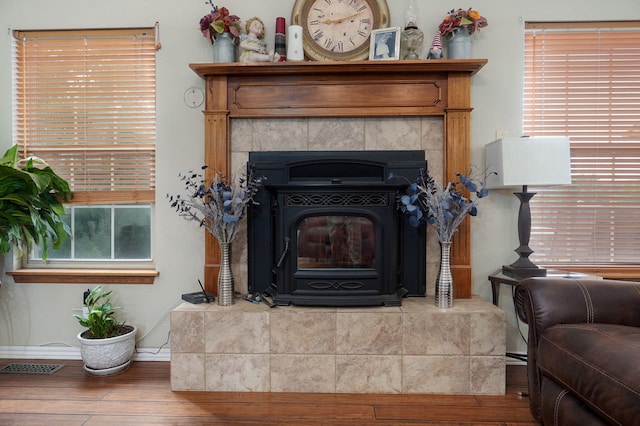 interior details featuring hardwood / wood-style floors and a wood stove