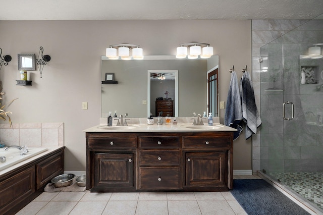 bathroom featuring tile patterned floors, ceiling fan, separate shower and tub, and vanity