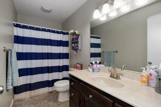 bathroom with walk in shower, toilet, tile patterned floors, vanity, and a textured ceiling