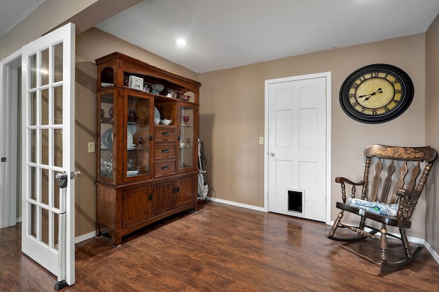 sitting room featuring french doors and dark wood-type flooring