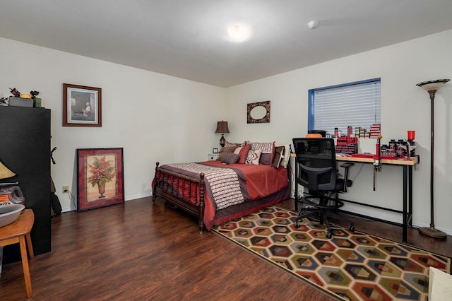 bedroom with dark hardwood / wood-style flooring