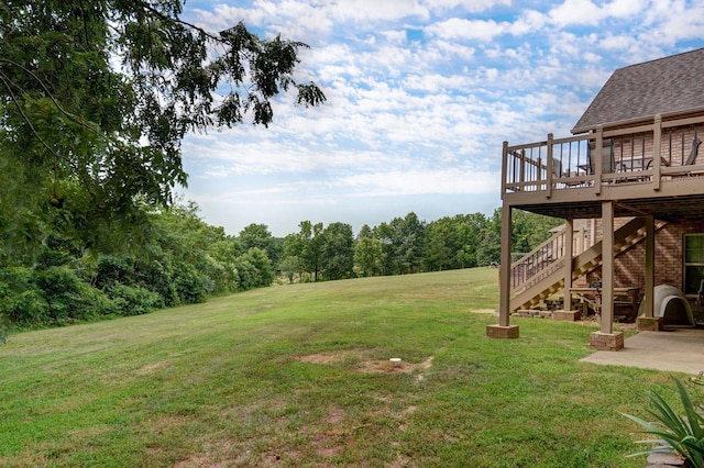 view of yard featuring a wooden deck and a patio area