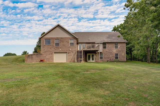 back of property with a wooden deck, a lawn, and a garage