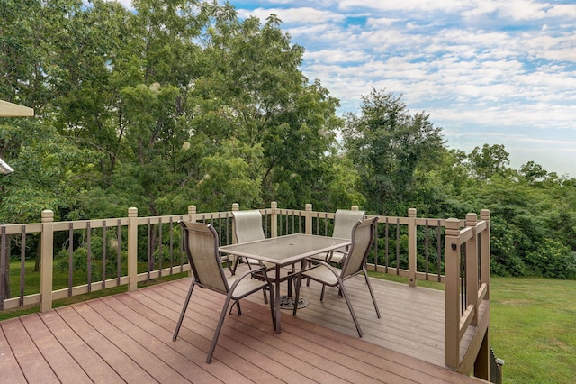 wooden terrace featuring a lawn