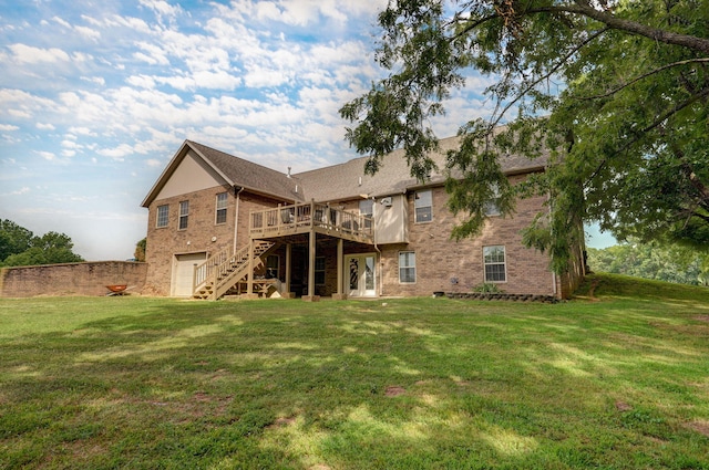 rear view of house with a deck and a yard