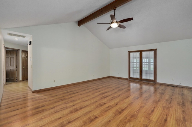 unfurnished living room featuring ceiling fan, french doors, light hardwood / wood-style floors, vaulted ceiling with beams, and a textured ceiling