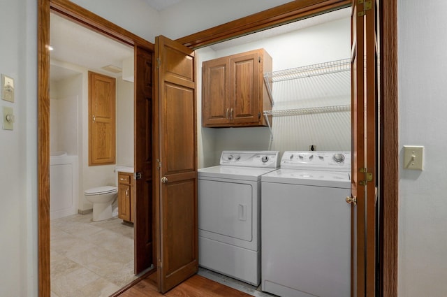 washroom featuring cabinets and washer and dryer