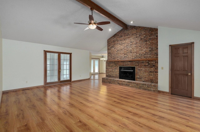 unfurnished living room featuring french doors, vaulted ceiling with beams, ceiling fan with notable chandelier, and light hardwood / wood-style floors