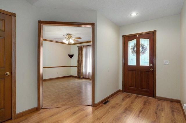 entryway featuring a textured ceiling, ceiling fan, and light hardwood / wood-style flooring