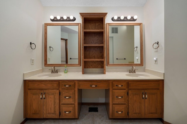 bathroom with vanity, a textured ceiling, and tile patterned floors