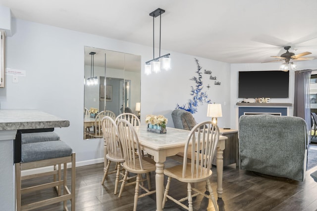 dining space with dark hardwood / wood-style floors and ceiling fan