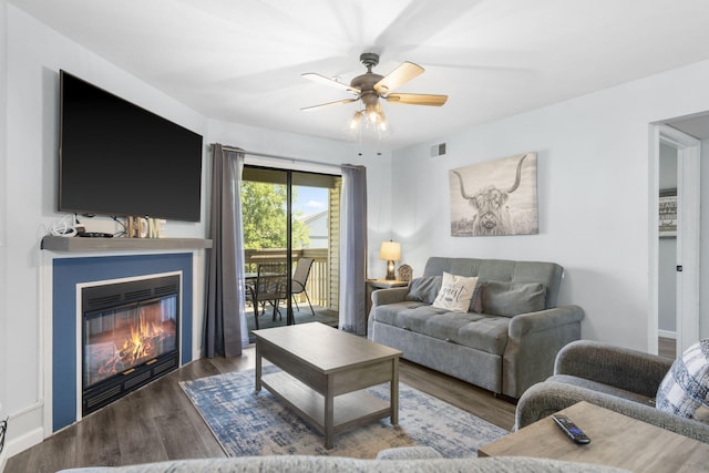 living room with ceiling fan and wood-type flooring