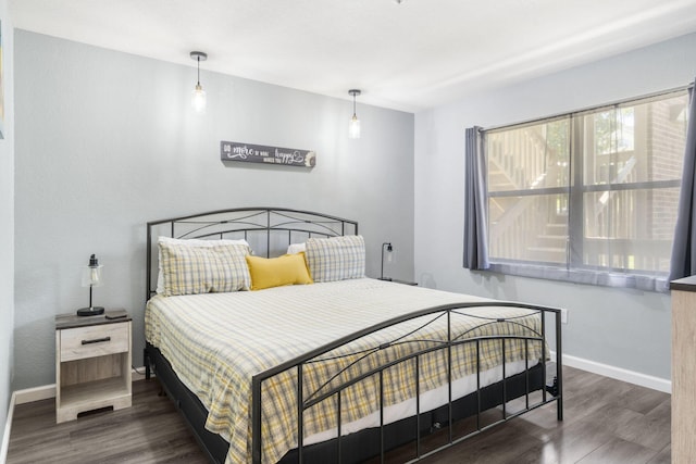 bedroom with dark hardwood / wood-style floors