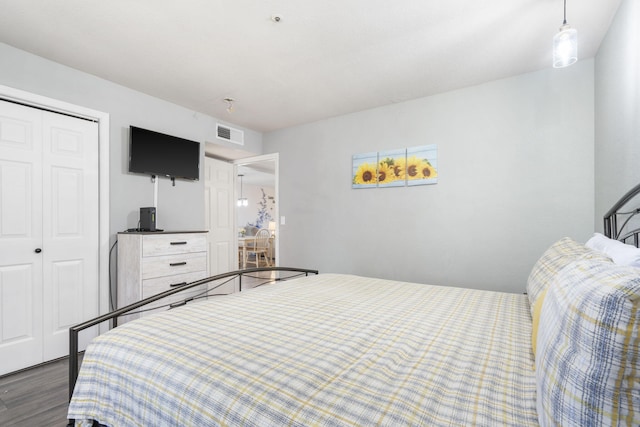 bedroom with hardwood / wood-style floors and a closet