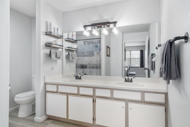 123 Bunker Ridge Dr Unit 7, Branson, MO 65616 - bathroom featuring toilet, a sink, double vanity, and a tile shower